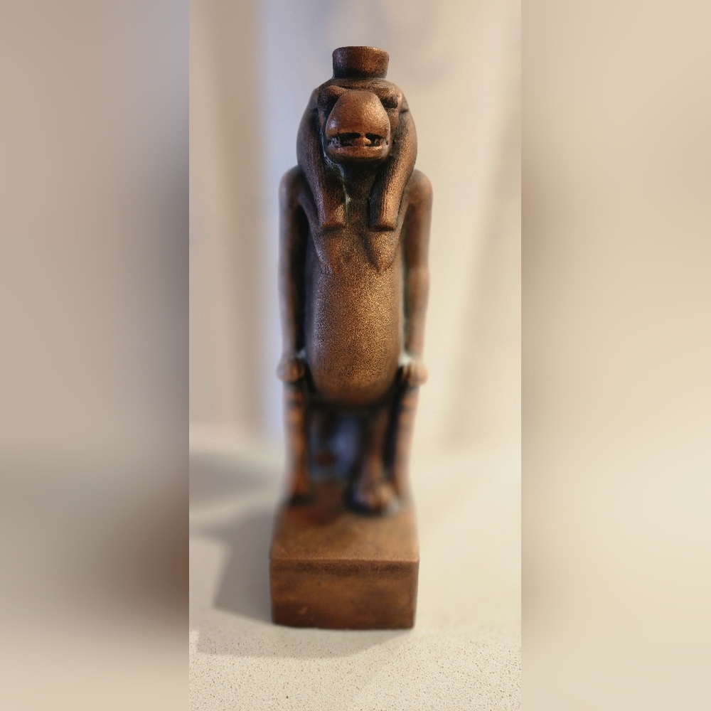 Patinated statue of the hippopotamus pharaoh.